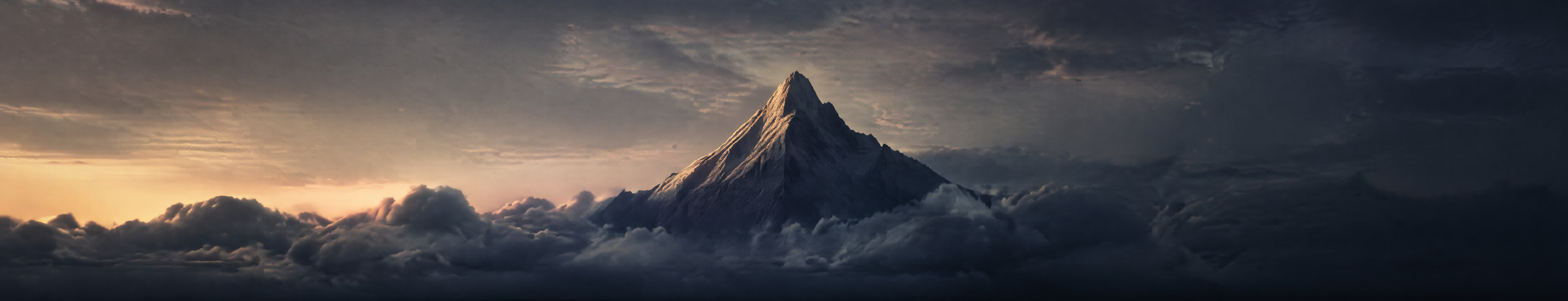 A single lit peak standing alone above a dark sea of cloud at dusk, the summit catching the last of the sun while everything around it has already gone to shadow